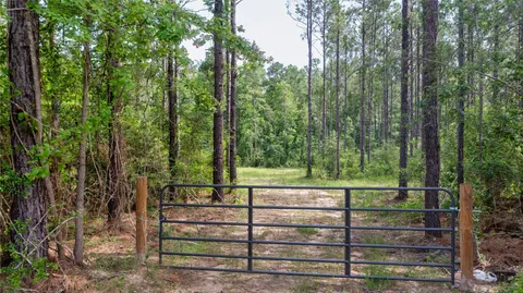a view of a wooden fence and trees