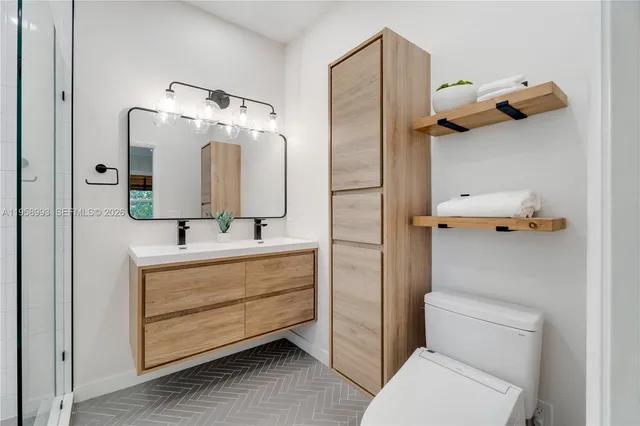 a bathroom with a toilet sink and mirror