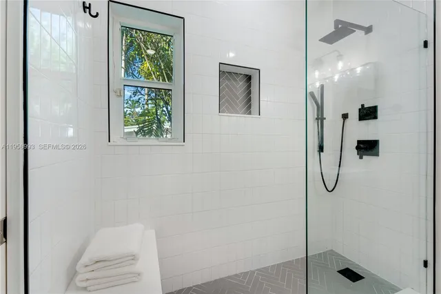 a bathroom with a glass shower door