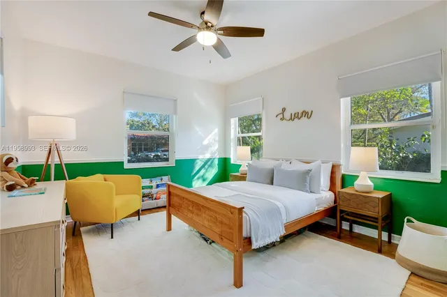 a bedroom with a bed chair and a window