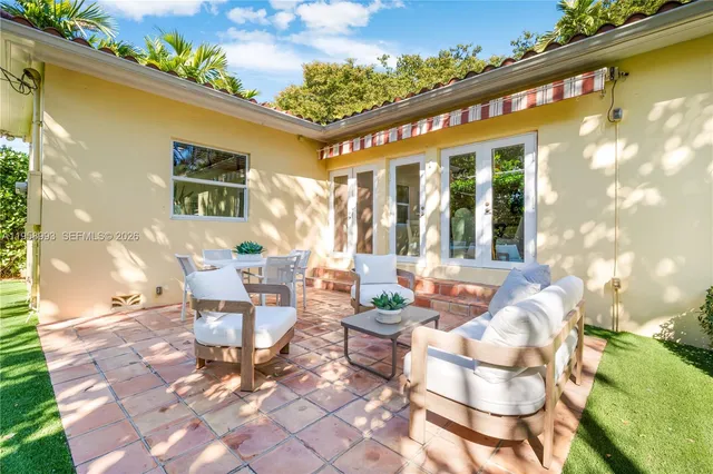 a front view of a house with outdoor seating