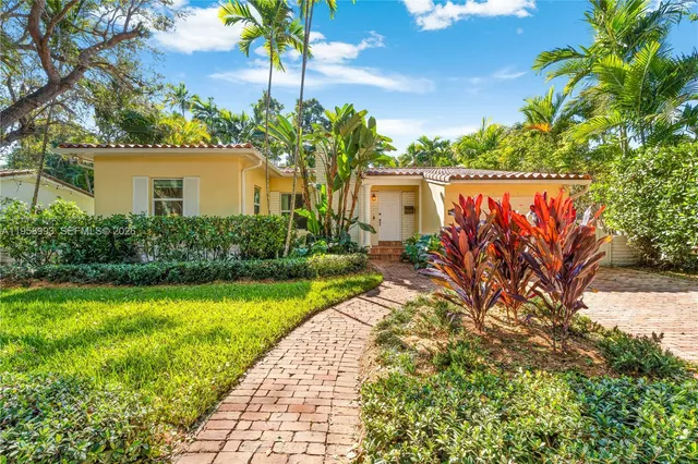 a view of a pathway with flower plants