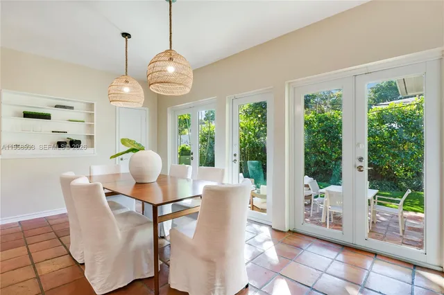 a dining room with furniture a chandelier and wooden floor