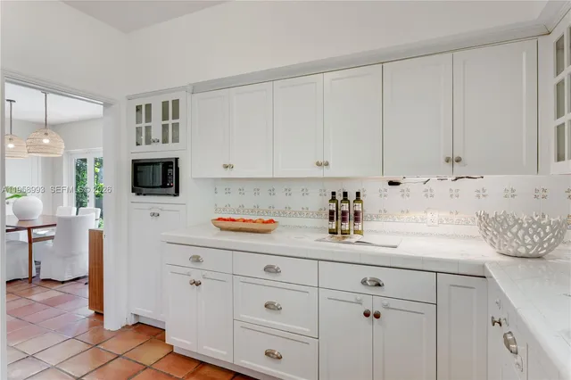 a kitchen with stainless steel appliances white cabinets and a sink