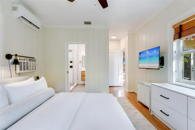 a bedroom with a bed and flat screen tv