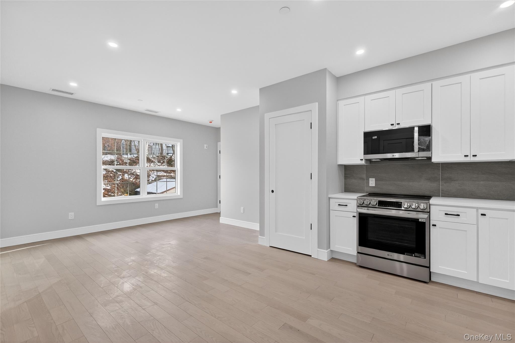 10 Market Street, Unit F Wappingers Falls, NY 12590 - Photo 4 of 14 a view of a kitchen with stainless steel appliances granite countertop a stove a sink and a microwave