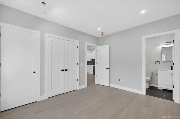 a view of a livingroom with kitchen space and bathroom space