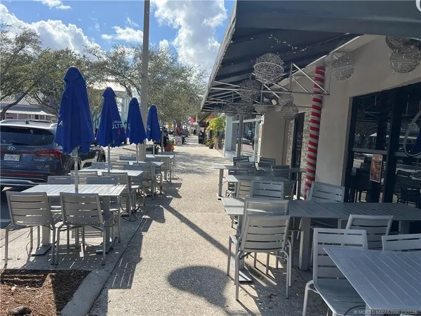 a view of a chairs and tables in the patio