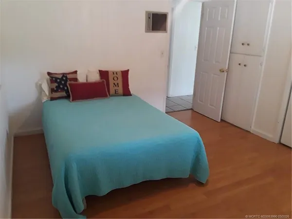 a bed sitting in a bedroom next to a window