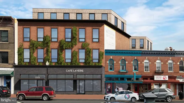 a front view of building with cars parked