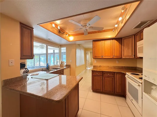 a kitchen with stainless steel appliances granite countertop a sink stove and cabinets