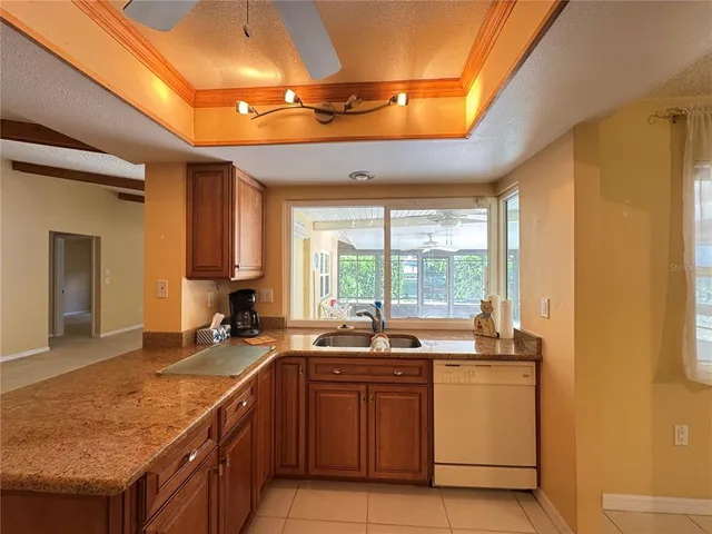 a kitchen with a sink a counter top space and a stove top oven