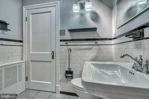 a bathroom with a sink mirror toilet and bathtub