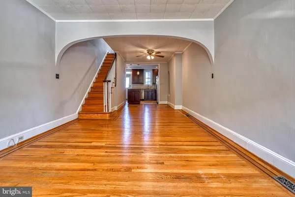 a view of empty room with wooden floor