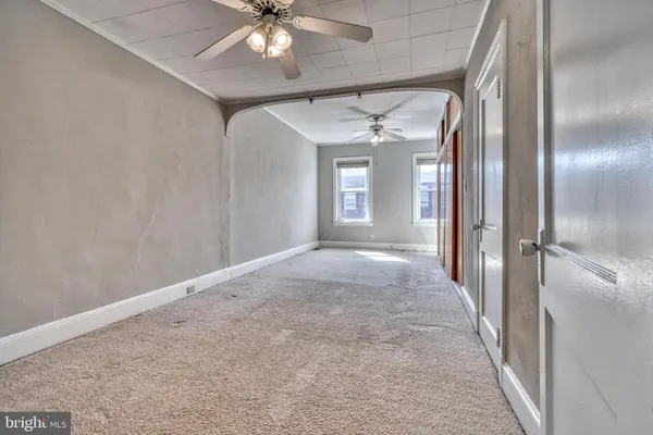 an empty room with windows and closet