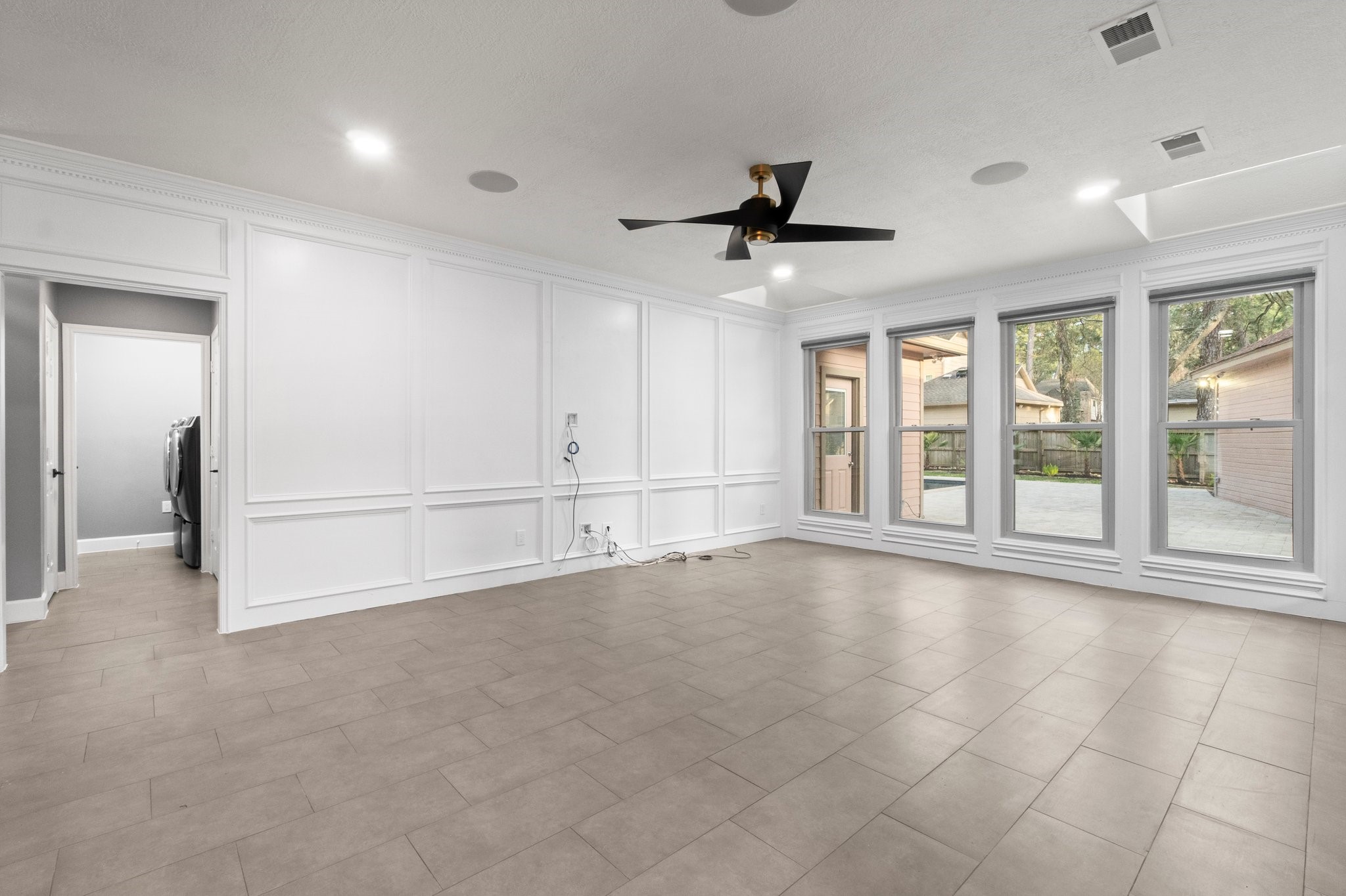31 Tanager Trail The Woodlands, TX 77381 - Photo 16 of 48 a view of an empty room with a window and a kitchen