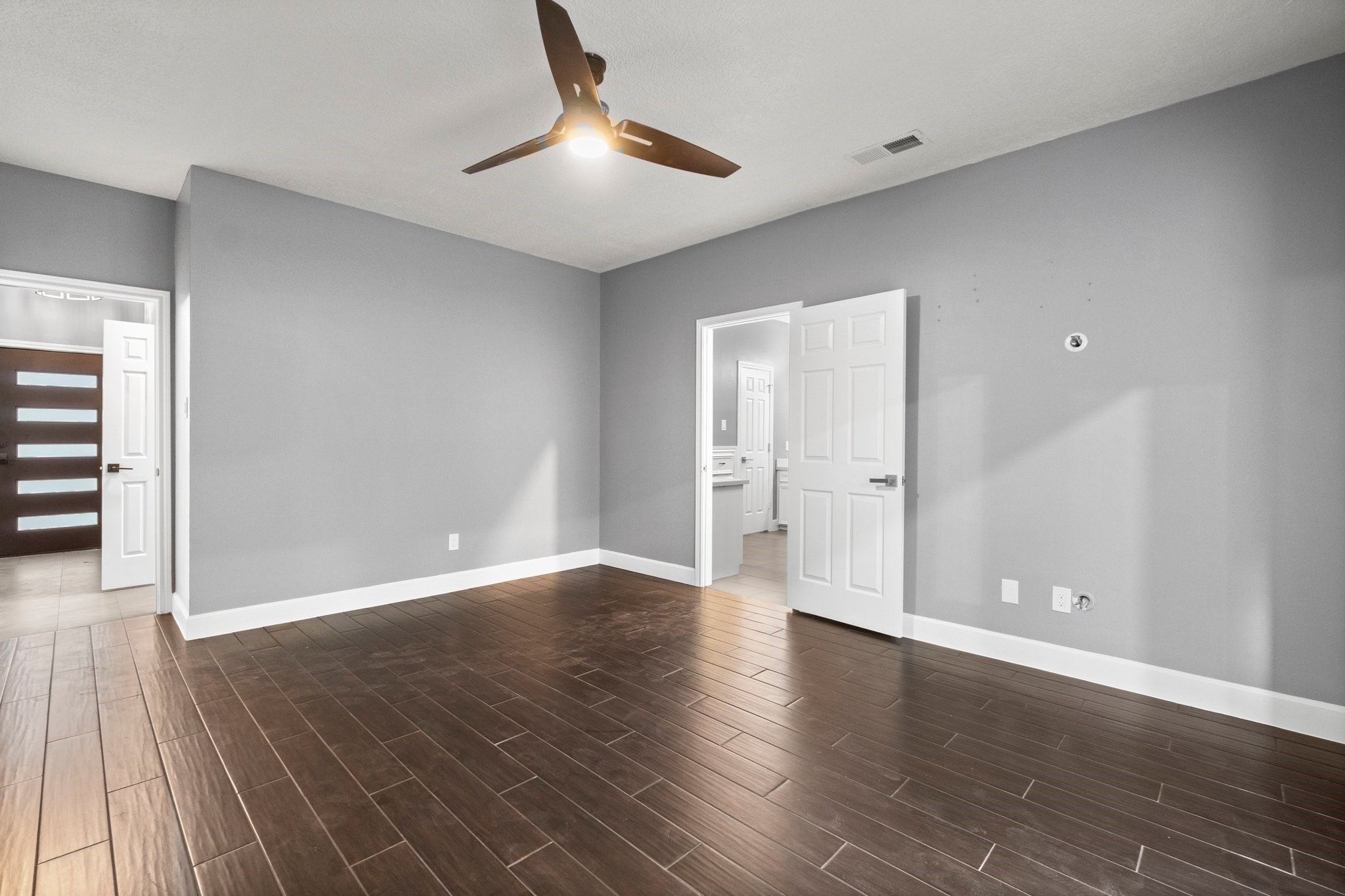 31 Tanager Trail The Woodlands, TX 77381 - Photo 17 of 48 an empty room with wooden floor and windows