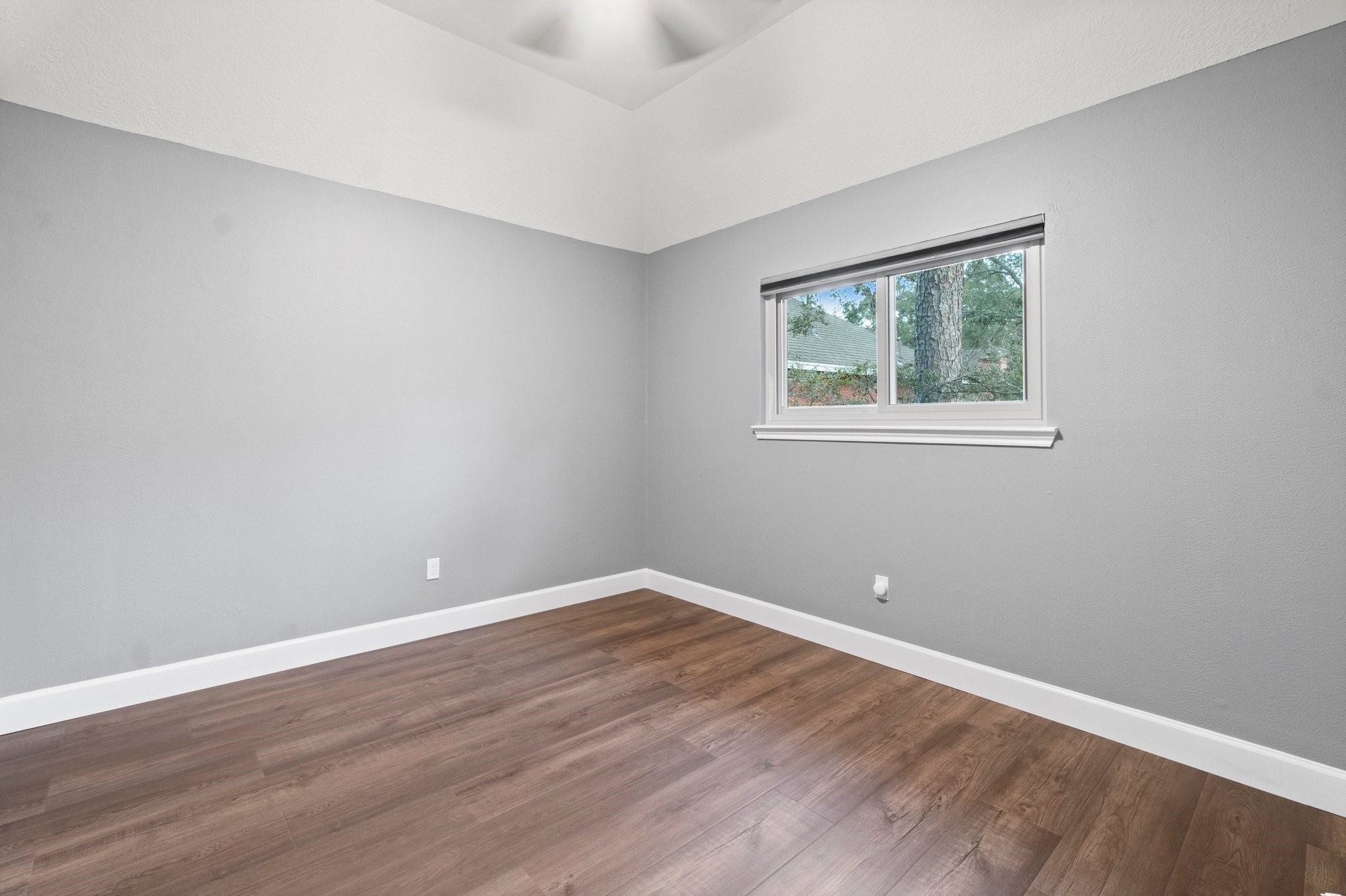 31 Tanager Trail The Woodlands, TX 77381 - Photo 25 of 48 a view of an empty room with wooden floor and a window
