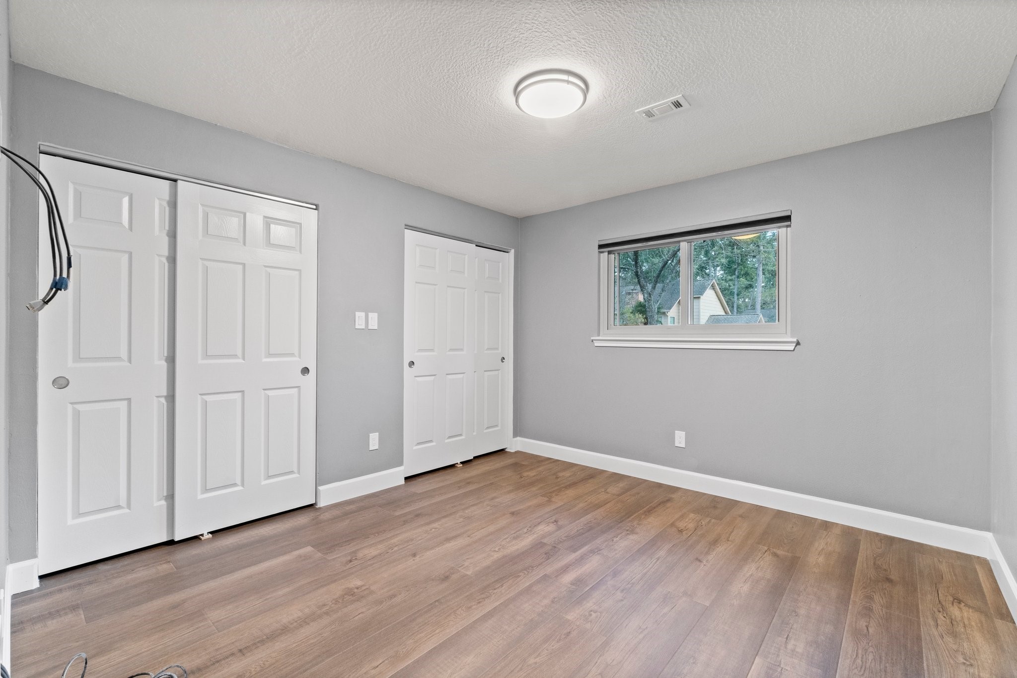 31 Tanager Trail The Woodlands, TX 77381 - Photo 28 of 48 a view of an empty room with wooden floor and a window
