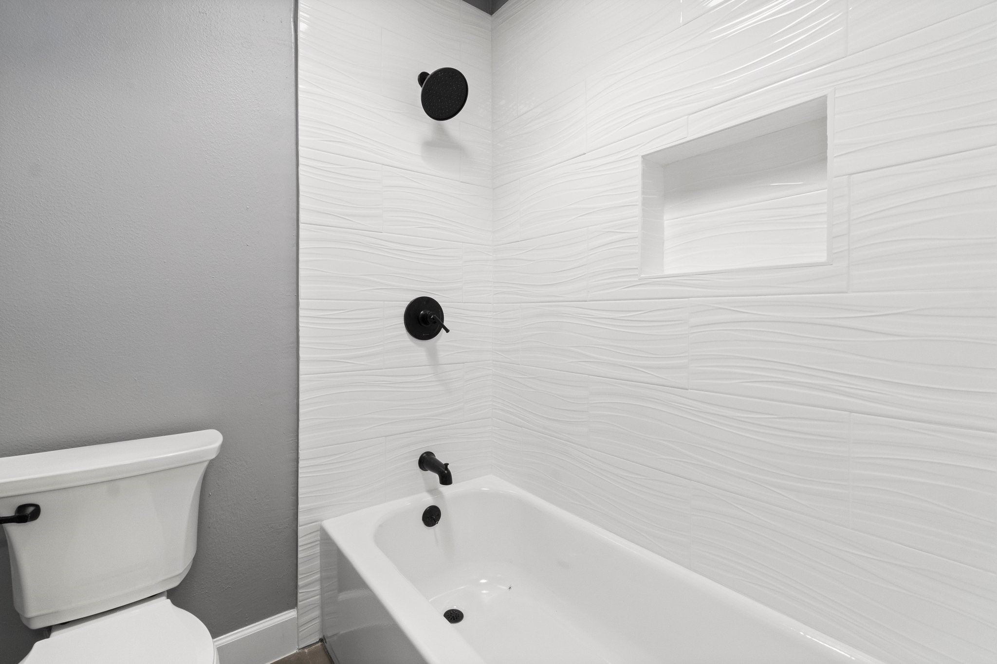 31 Tanager Trail The Woodlands, TX 77381 - Photo 32 of 48 a white bath tub sitting next to a toilet