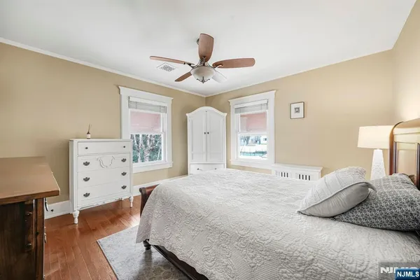 a spacious bedroom with a bed and a cabinets