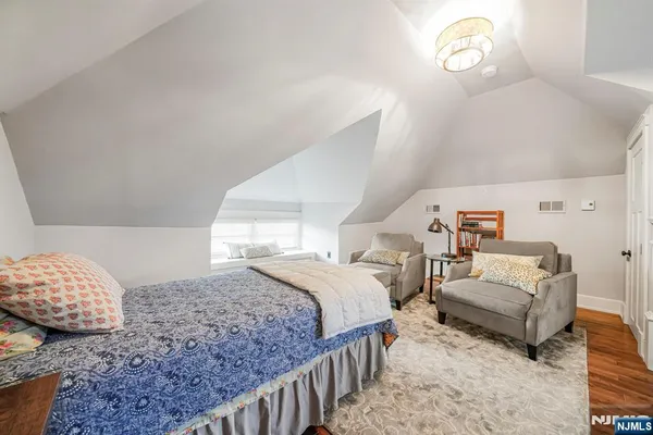 a bedroom with a bed and a couch