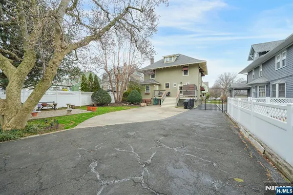 a view of a house with a yard and garage