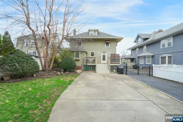 a view of a house with a yard and potted plants