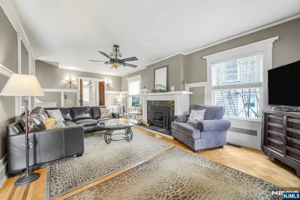 a living room with furniture a flat screen tv and a fireplace