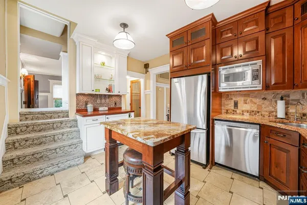 a kitchen with stainless steel appliances granite countertop a stove and more cabinets