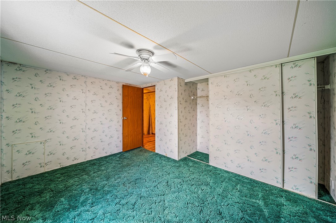 3471 Fox Road Kingsville, OH 44048 - Photo 28 of 50 Carpeted empty room with a textured ceiling and ceiling fan