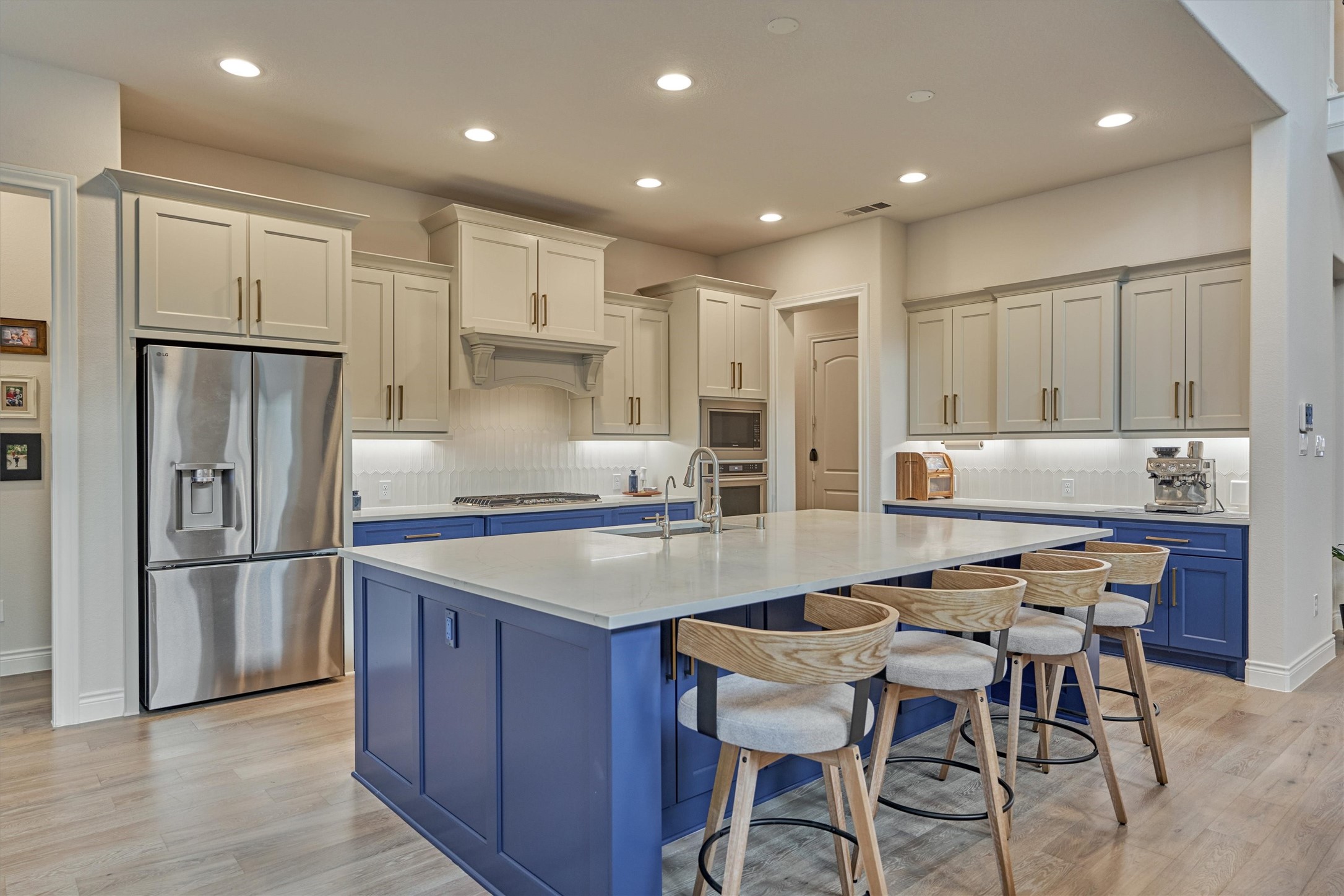 15230 Tree Swallow Court Magnolia, TX 77354 - Photo 18 of 49 a kitchen with stainless steel appliances granite countertop a table chairs sink refrigerator and microwave