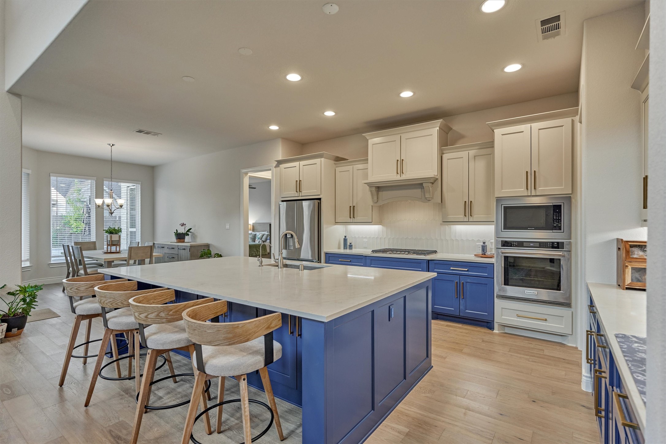 15230 Tree Swallow Court Magnolia, TX 77354 - Photo 19 of 49 a large kitchen with a table and chairs