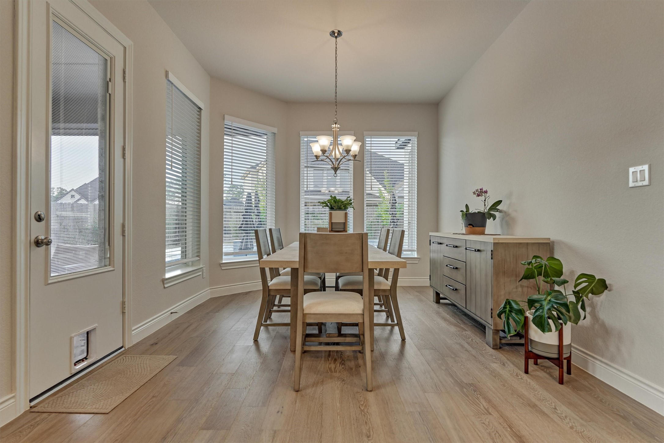15230 Tree Swallow Court Magnolia, TX 77354 - Photo 22 of 49 a dining room with furniture a chandelier and wooden floor