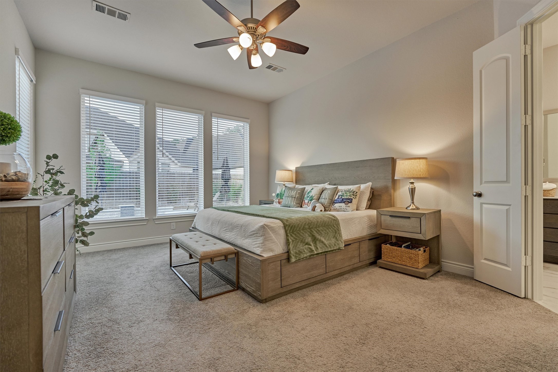 15230 Tree Swallow Court Magnolia, TX 77354 - Photo 23 of 49 a spacious bedroom with a bed and a chandelier