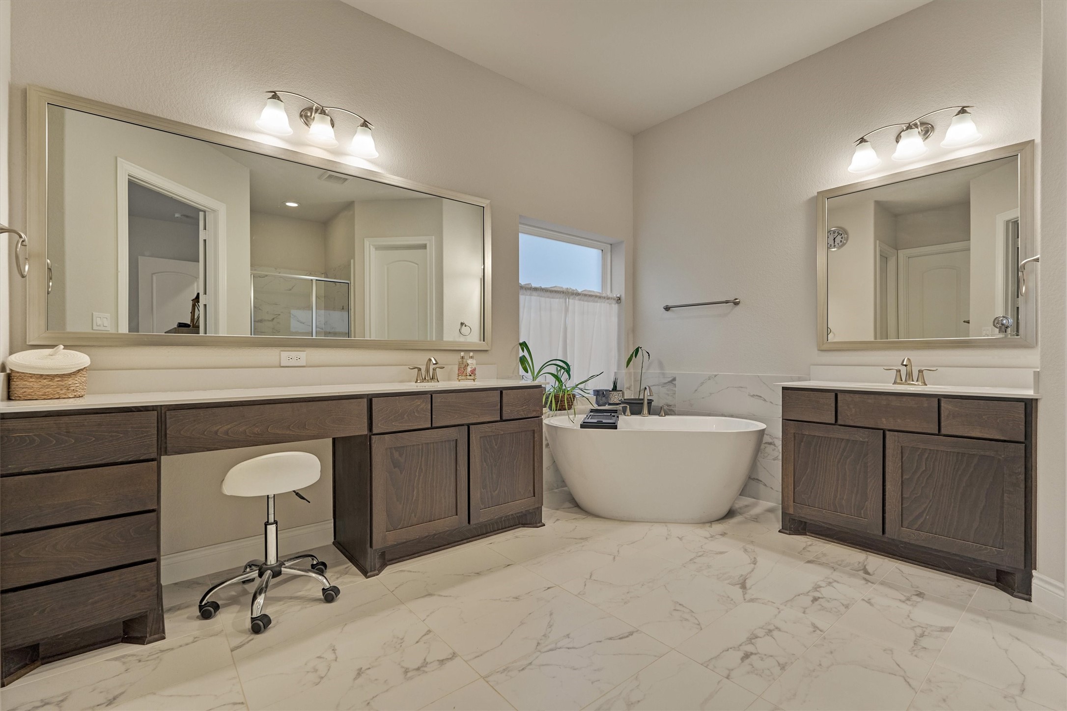 15230 Tree Swallow Court Magnolia, TX 77354 - Photo 25 of 49 a bathroom with a sink a bathtub a mirror and vanity