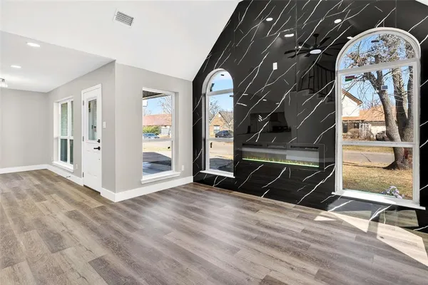 a view of an entryway with wooden floor