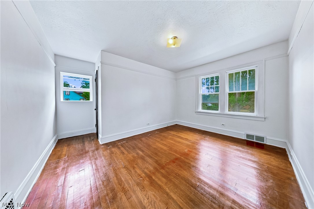 24958 Kennedy Ridge Road North Olmsted, OH 44070 - Photo 25 of 43 Hardwood flooring, multiple windows, ceiling-mounted light fixture, white trim, and light-toned walls