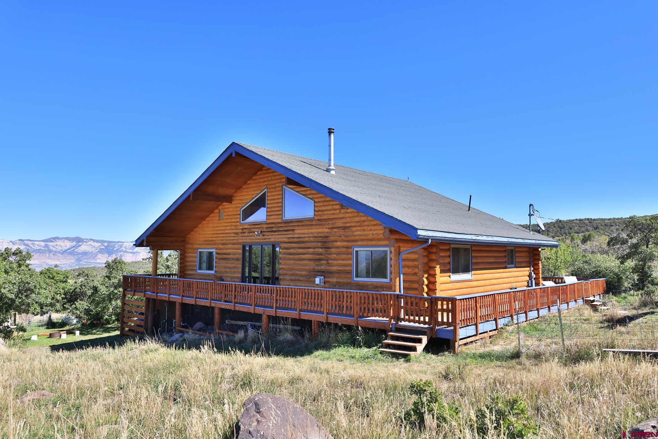 9321 54 Road Molina, CO 81646 - Photo 2 of 32 a front view of a house with a yard