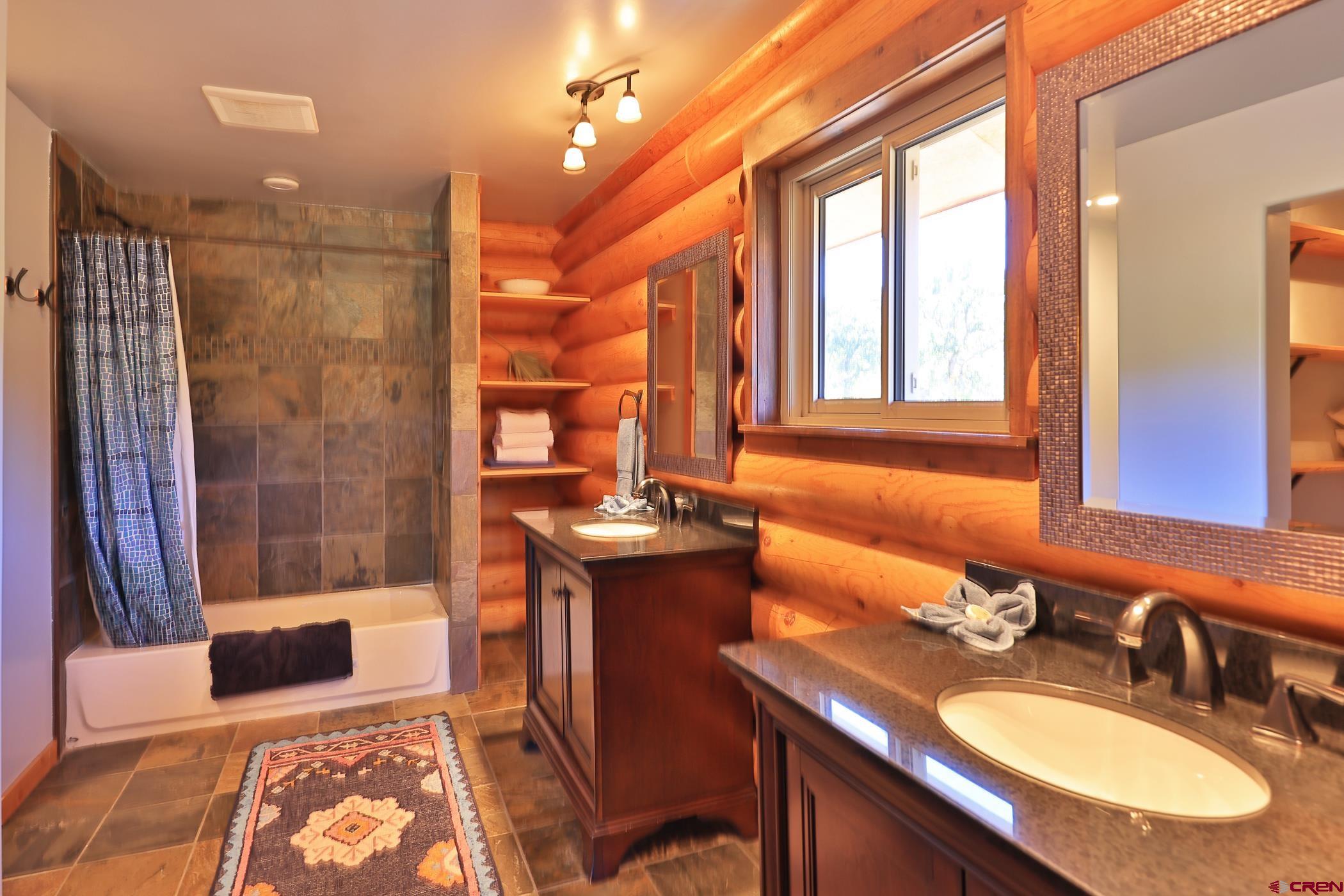 9321 54 Road Molina, CO 81646 - Photo 14 of 32 a bathroom with a sink double vanity and a mirror