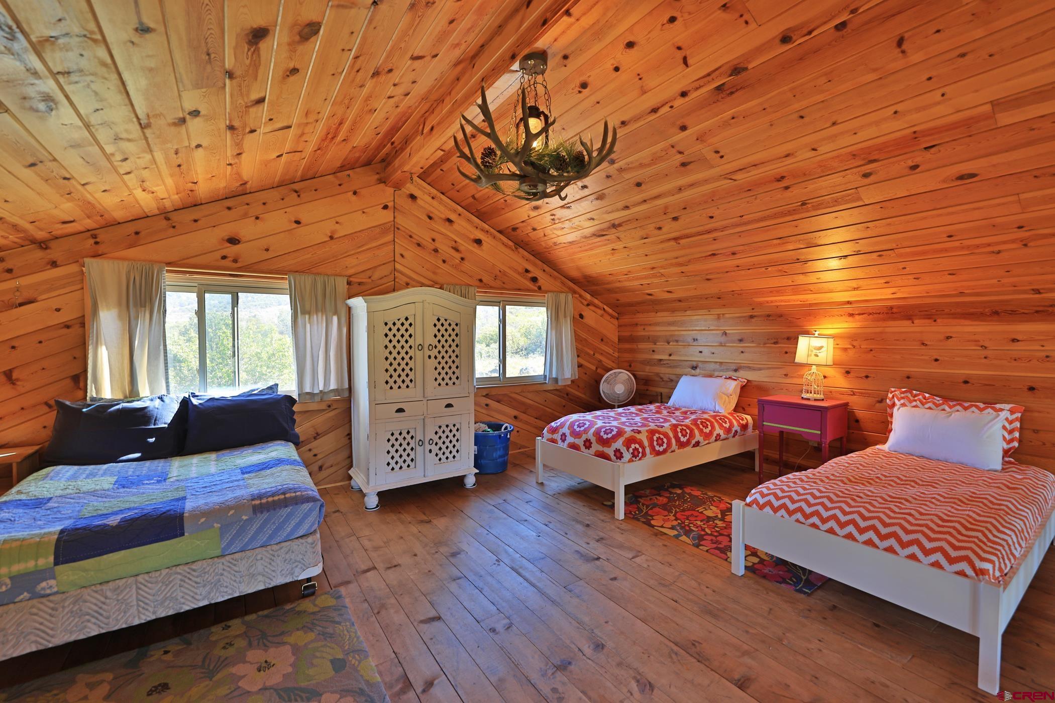 9321 54 Road Molina, CO 81646 - Photo 10 of 32 a bedroom with furniture and wooden floor