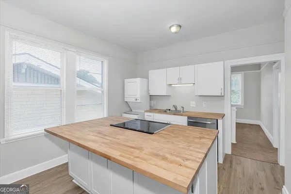 a kitchen with granite countertop a sink and a stove