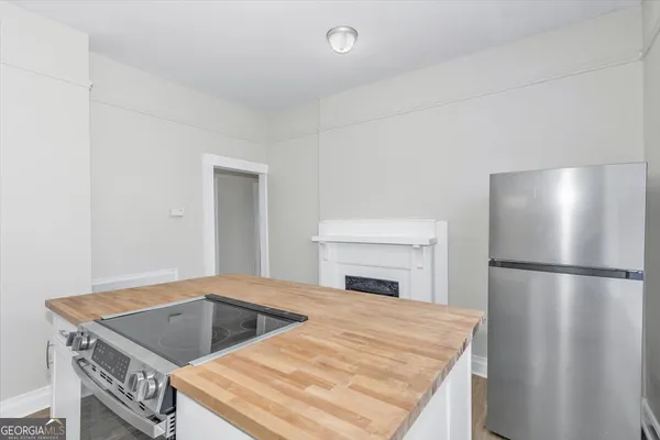 a kitchen with a stove a refrigerator and a sink