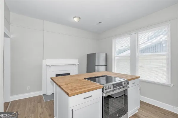 a kitchen with a stove and a window