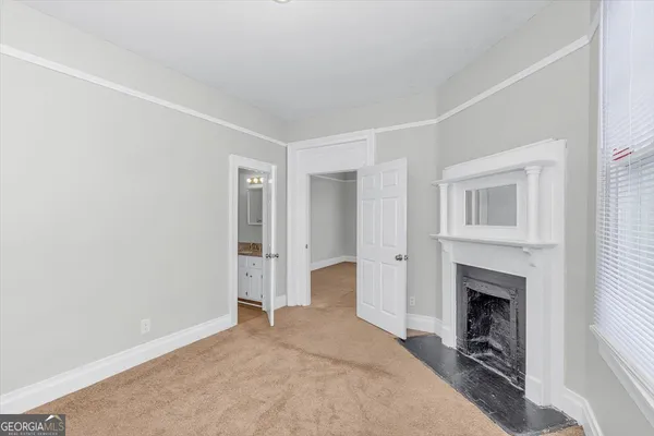 a big room with closet and a fireplace