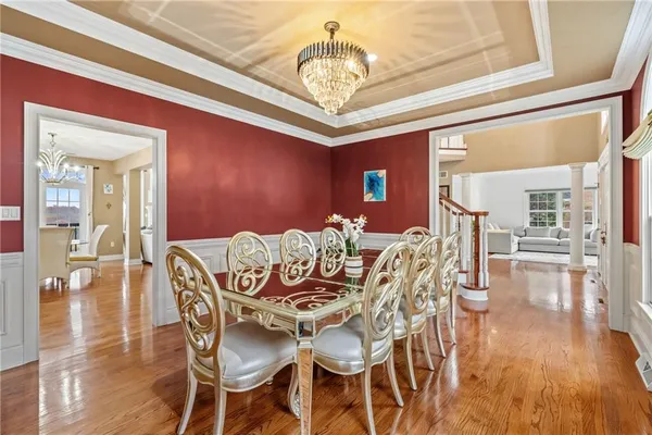 a view of a dining room with furniture wooden floor and chandelier