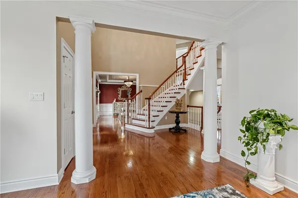 a view of entryway and hall with wooden floor