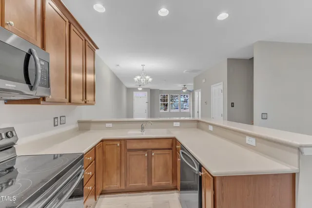 a kitchen with a sink stove and cabinets