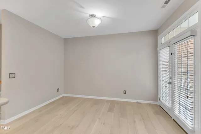 an empty room with a empty space and windows