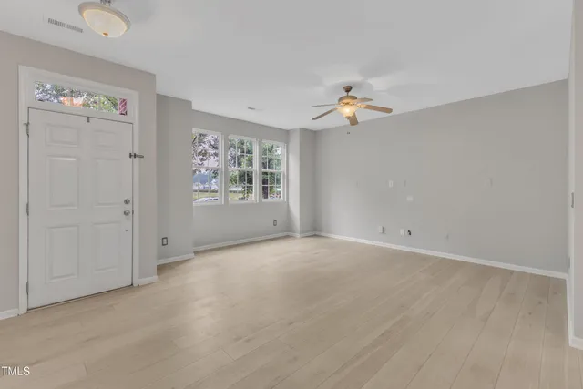 wooden floor in an empty room with a window